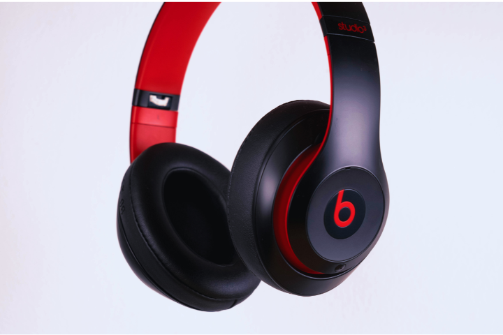 Black and red over-ear headphones, featuring a prominent "b" logo on the ear cup, set against a plain white background.