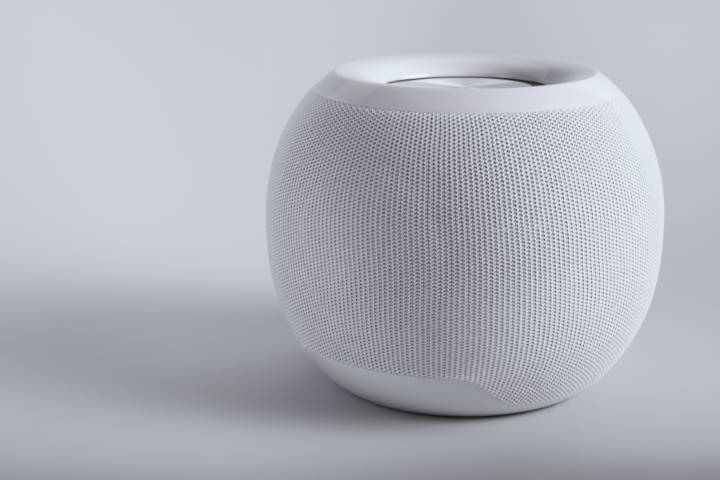 A smooth, white spherical speaker with a mesh texture on a light grey background.