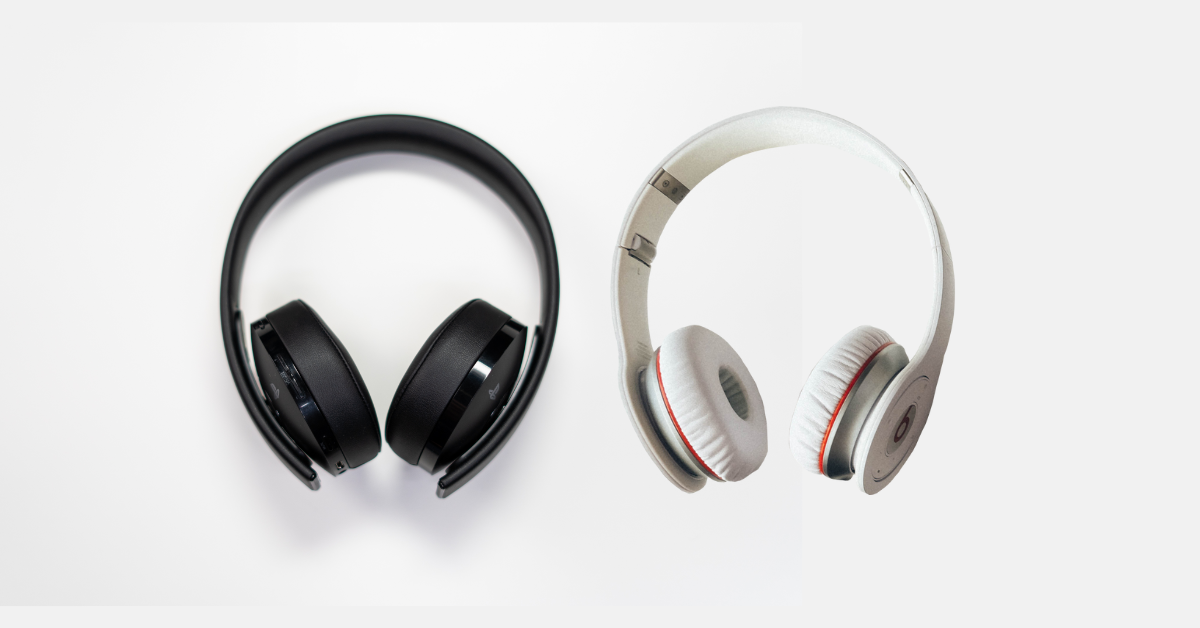 Two pairs of over-ear bass headphones Two pairs of over-ear bass headphones on a white background. The left pair is black, sleek and modern, while the right pair is white with red accents.