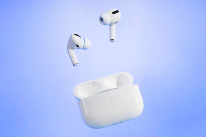 Wireless earbuds float above an open charging case against a soft blue background.