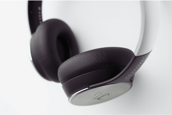 Close-up of sleek, black and white over-ear headphones on a white background.