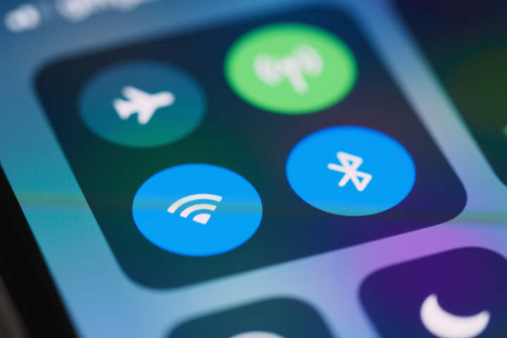 Close-up of a smartphone screen showing Wi-Fi, Bluetooth, Airplane Mode, and other connectivity icons.